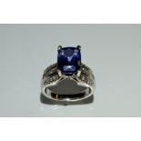 A Tanzanite and diamond ring, central cushion cut rectangular tanzanite approx 4ct,