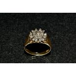 A diamond cluster ring, triple layered floral cluster,