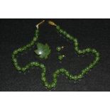 A stained deep green nephrite effect globular bead necklace, each individually knotted, oval clasp,