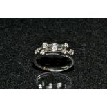 A diamond ring, open triple bar platform inset with seven individually mounted diamond accents,