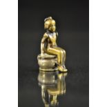 A Novelty cast steel and brass cigar cutter, figure seated upon a chamber pot, hinged action,