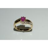 A ruby and diamond dress ring, central oval pinky red ruby,