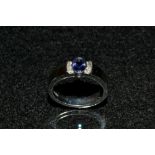 A tanzanite and diamond ring, central oval collet set tanzanite,