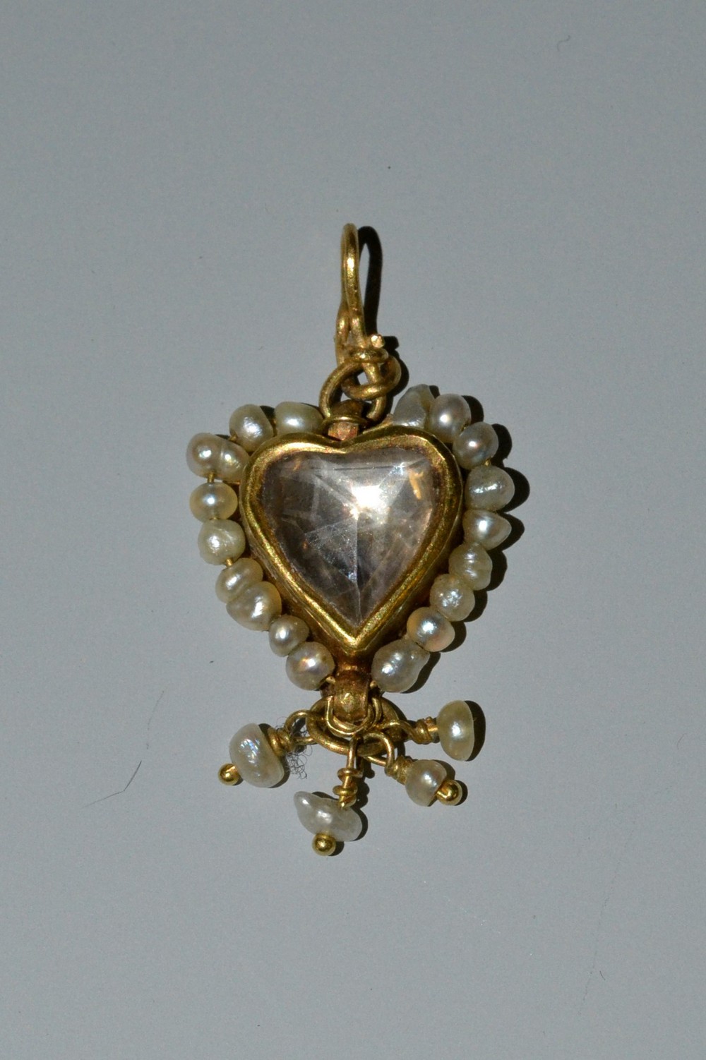 A 19th century rock crystal and seed pearl mounted heart pendant,