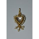 A 19th century rock crystal and seed pearl mounted heart pendant,