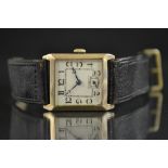 An Art Deco gold cased dress watch, square case and silvered dial, painted Arabic numerals,