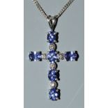 A tanzanite and diamond cross pendant necklace,