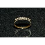 A diamond 1/2 eternity ring, linear inset with nine round cut diamonds,