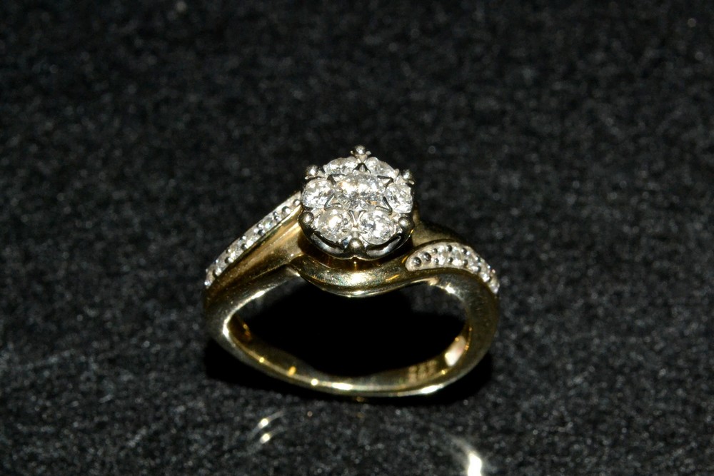 A diamond cluster ring, raised seven stone flower head,