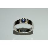 A tanzanite and diamond ring, central oval tanzanite,