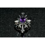 A Gothic dress ring, eight point platform crest inset with a single central oval amethyst,