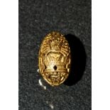 A South American Peruvian gold ring, pierced arched oval crest decorated with an Incan sun deity,