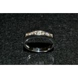 A diamond half eternity ring, channel set with seven round cut diamonds,