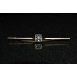 An Aquamarine bar brooch, central set with a single square cut aquamarine,