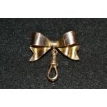 An Edwardian 9ct gold tied ribbon bow and drop loop fob watch suspension brooch, S Ward & son,