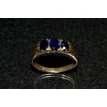 A synthetic sapphire three stone ring,