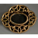 A Victorian rose metal mourning brooch, shaped scroll design with black enamel ground,