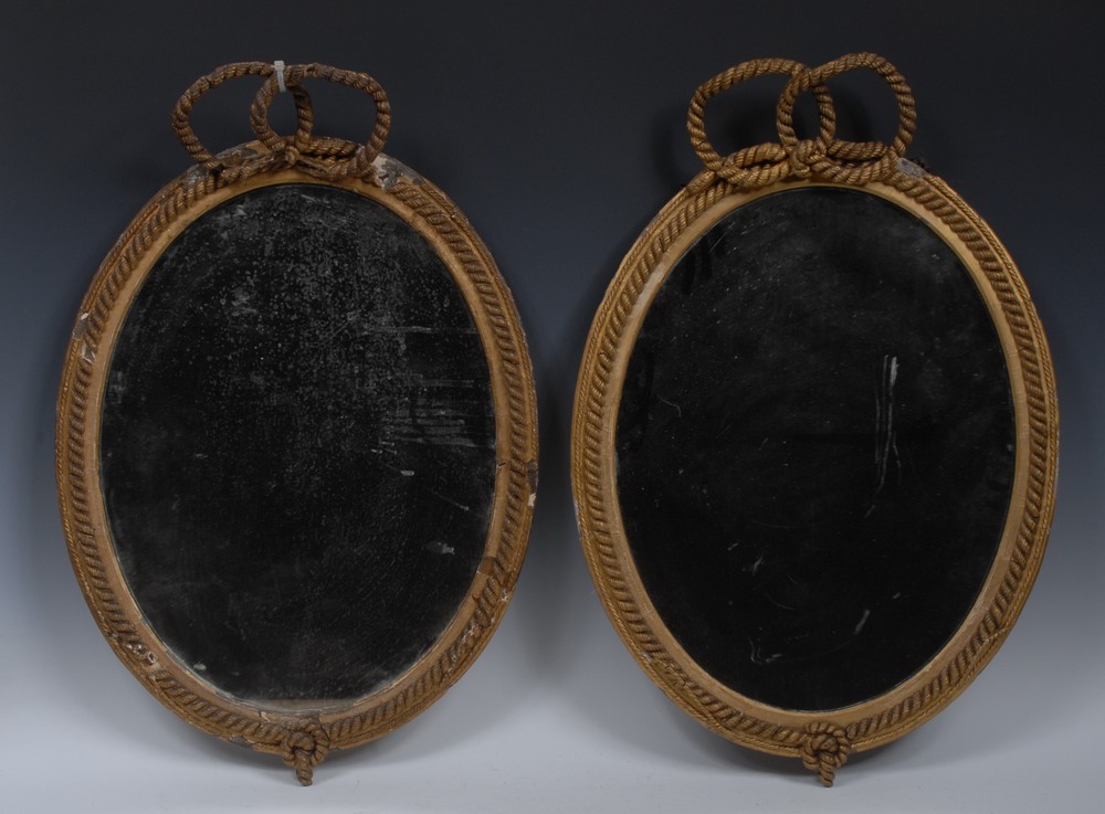 A pair of 19th century giltwood and gesso oval looking glasses,