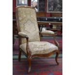 A Victorian walnut armchair, padded back, outswept open arms, serpentine stuffed overseat,