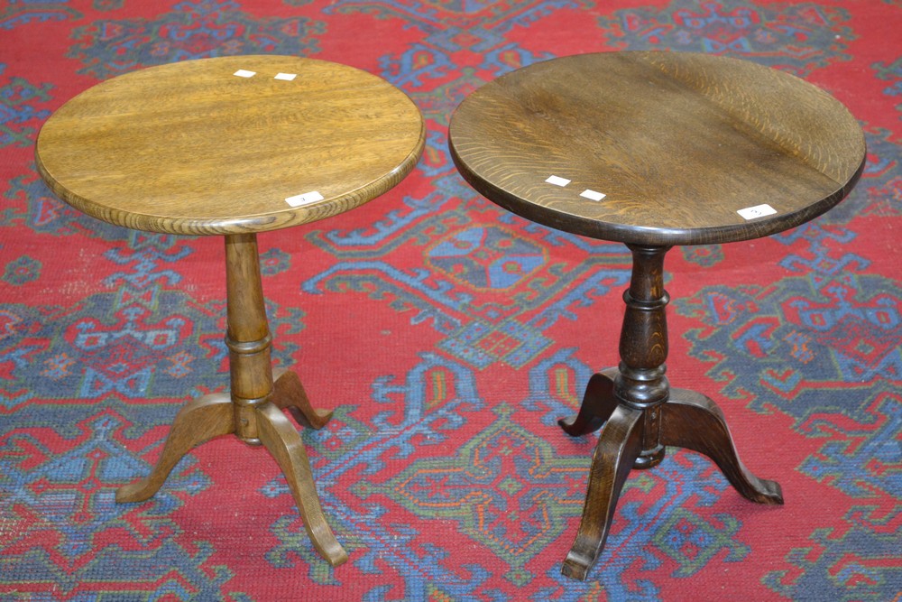 Two oak tripod tables, circular top, turned columns, cabriole legs.