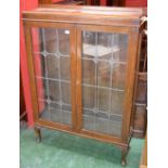 An early 20th century oak leaded glazed display cabinet, c.