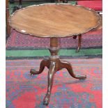 A George III mahogany tripod supper table, dished tilting top with piecrust border,