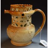 A 19th century brown salt glazed stoneware puzzle jug, pierced with hearts and geometric motifs,