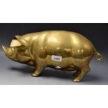 A large brass money bank modelled as a pig