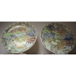 A large pair of Japanese circular chargers, decorated with figures, peonies, flowers, pine tree,