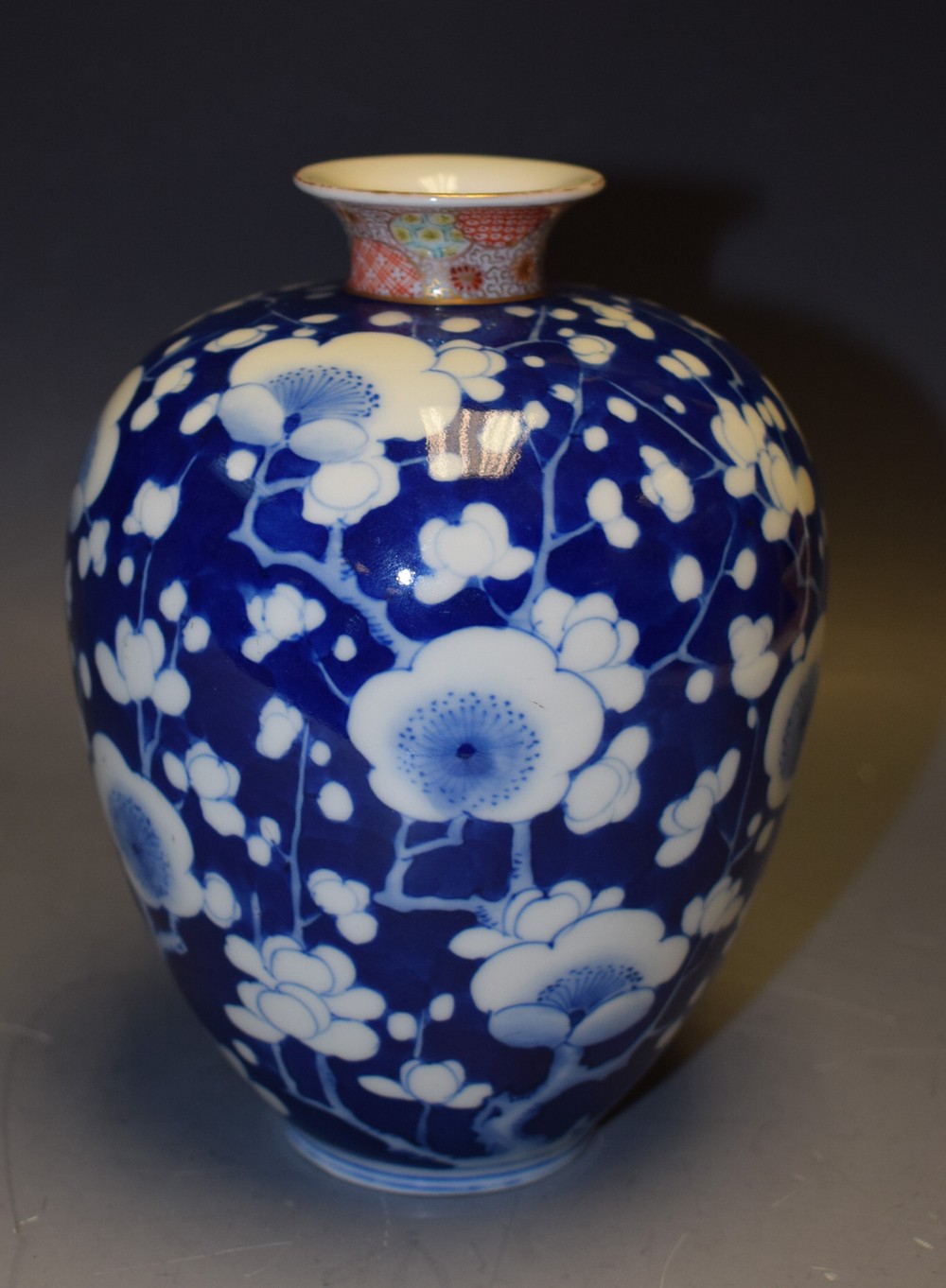 A Japanese ovoid vase, decorated in underglaze blue with cherry blossom,