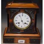 A Victorian walnut and ebonised mantel clock