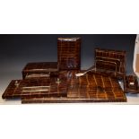 An Art Deco style faux crocodile desk set, comprising blotter, letter rack, cigarette box,