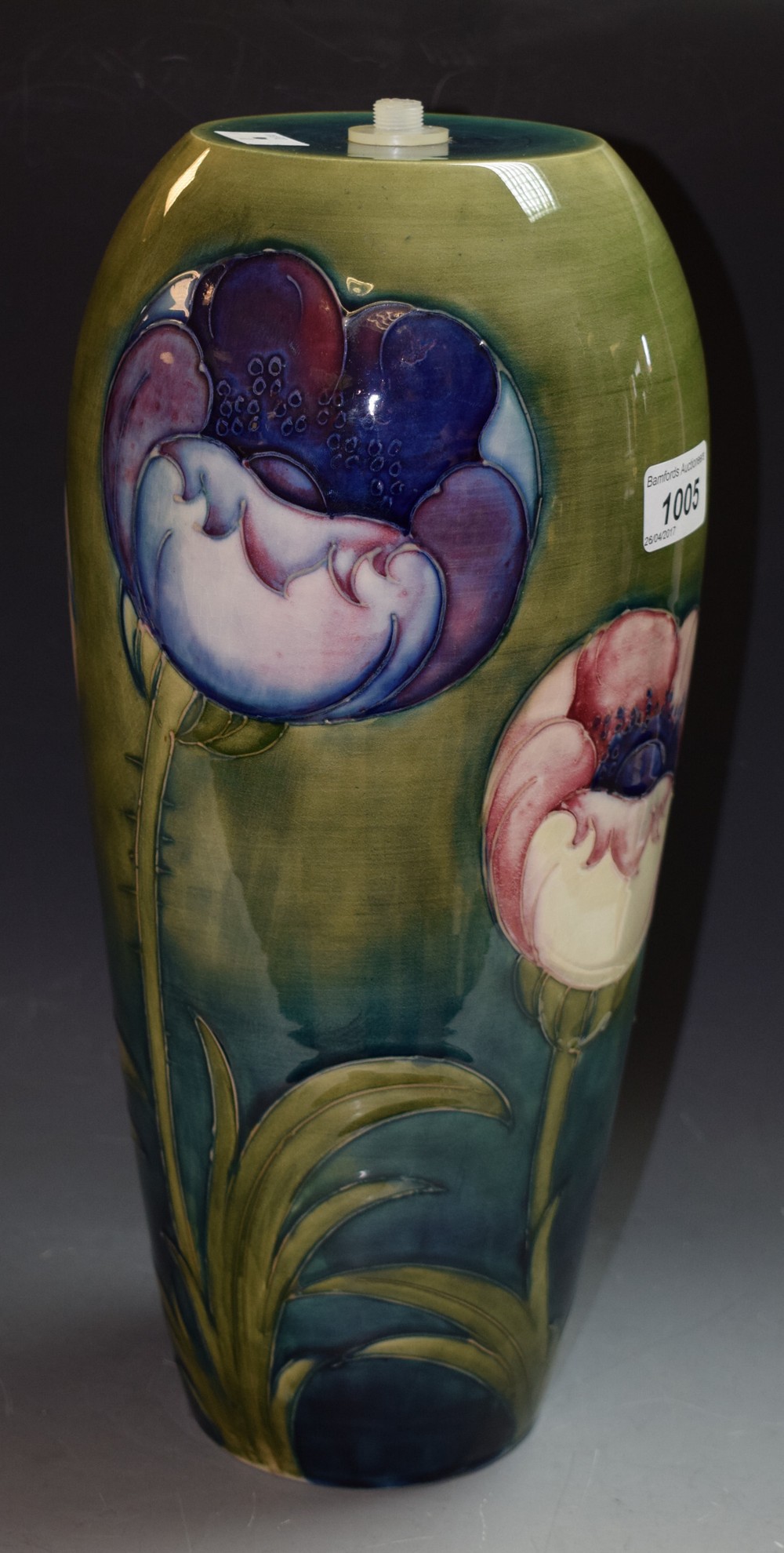 A Moorcroft Poppy pattern ovoid lamp basetubelined with large flowerheads on a green ground, 35.