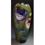 A Moorcroft Poppy pattern ovoid lamp basetubelined with large flowerheads on a green ground, 35.