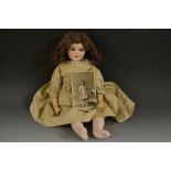 An Edwardian French bisque head doll, sleeping blue eyes, open mouth, brown hair,