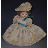 A Bruno Schmidt bisque head doll, with brown glass sleeping eyes, open mouth, two upper teeth,