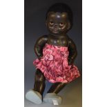 A mid 20th century composition black doll, sleeping brown eyes, red painted mounth, lambs wool hair,