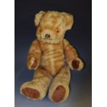 A 1960's Dean's dark golden plush mohair jointed teddy bear, amber and black plastic eyes,