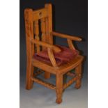 An early 20th century oak dolls chair, the rectangular back with two turned spindles,