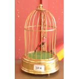A singing bird automaton in a gilt cage.