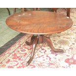 A George III low occasional table, circular top, turned column, three cabriole legs, pad feet.