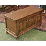 An oak blanket chest, hinged top, linenfold panels to front. 46cm high x 95cm wide x 37cm deep.