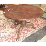 A George III low occasional table, circular top, turned column, three cabriole legs, pad feet.