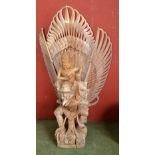 An Indonesian wooden sculpture of Bhagwan Vishnu riding Garuda. 147cm high x 78cm wide.