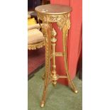 A giltwood jardiniere in the Empire taste, circular top, torch under finial, carved supports,
