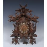 A German Black Forest cuckoo clock, 14cm dial with Roman numerals,
