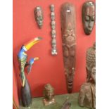 Indonesian carved masks; a wooden toucan; a wooden carved Buddha head.