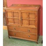 An oak tallboy by Hunters of Derby, galleried back, two panel doors over two graduated long drawers,