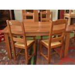 A modern designer Mark's and Spencer oak slat top table and four oak rush seated ladder back chairs
