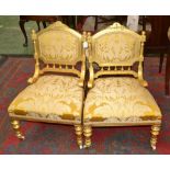 Two Louis XVI revival giltwood nursing chairs, carved cresting top rail, padded back,